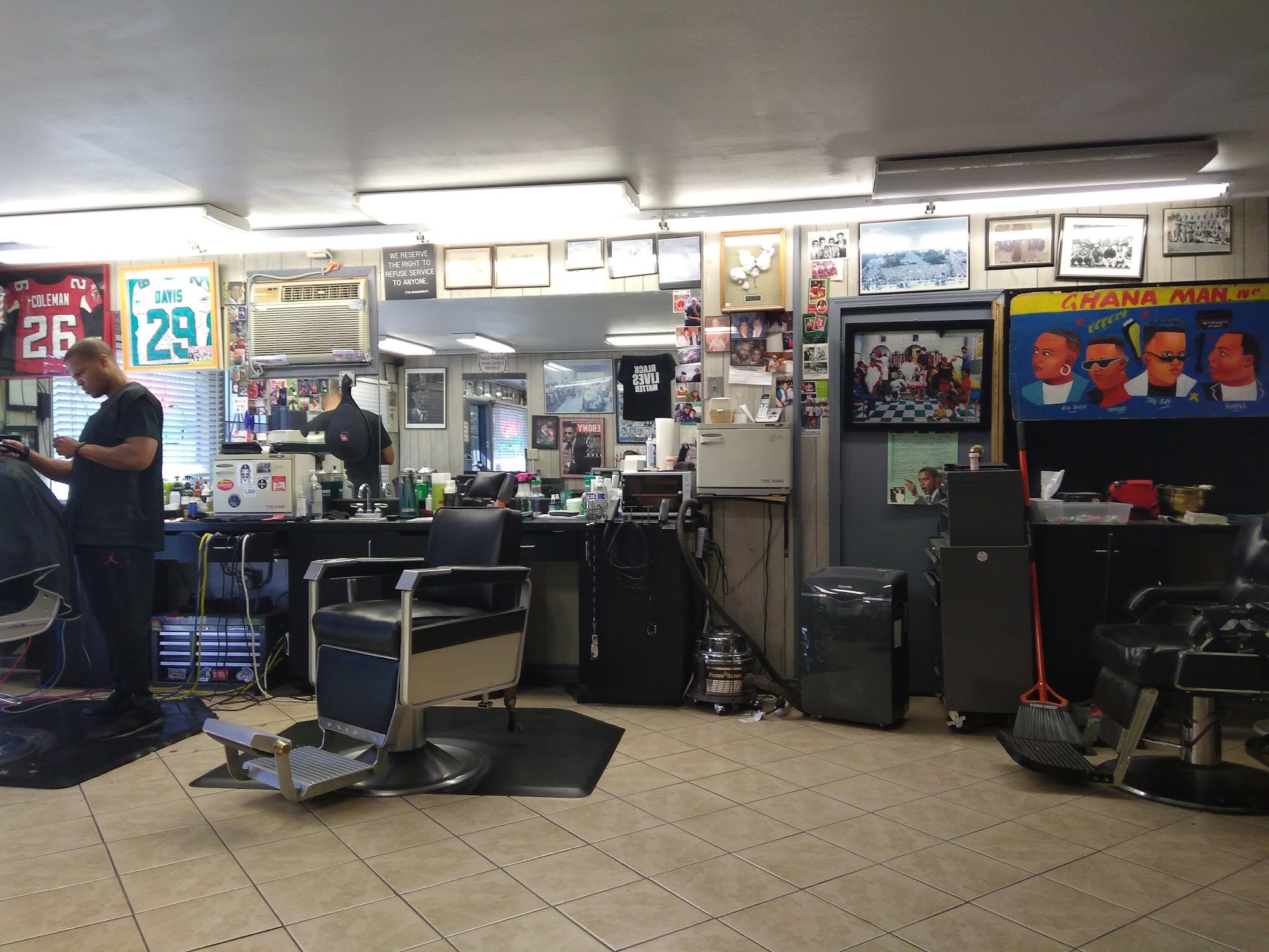 Photograph-lined walls and barber chairs at Larry’s